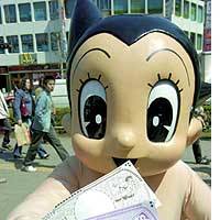 Astro Boy displays some Astro Boy money in front of JR Takadanobaba Station. | PHOTO COURTESY OF KYOTO PREFECTURE