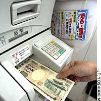 A 2,000 yen bank note is withdrawn from an automated teller machine at a Lawson convenience store in Tokyo. | &#160; PHOTO COURTESY OF BANDAIJIN ECO GAIDO NO KAI (AN ASSOCIATION OF BANDAI ECOTOUR GUIDES)