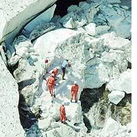 Rescuers search for three hikers who were buried when an ice cave on Mount Arasawa in Niigata Prefecture collapsed on Sunday. | AKEMI NAKAMURA PHOTO