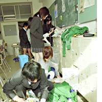 Students at Ojiya Municipal Nishi Senior High School clean up their classroom Monday on the first day of school after a series of powerful earthquakes hit Niigata Prefecture. | AKEMI NAKAMURA PHOTO