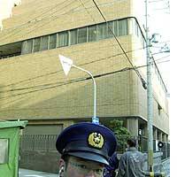 A police officer guards the Chinese Consulate General in Osaka on Sunday after a man hurled a bottle at it and set himself on fire. | PHOTO COURTESY OF ASUKA MUNICIPAL GOVERNMENT