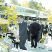Relatives of victims of a fatal train collision in 1991 and JR West officials hold a memorial service Sunday in Koka, Shiga Prefecture, on the 15th anniversary of the accident. | KAZUAKI NAGATA PHOTO