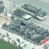 This photo taken in 2003 shows a North Korean freighter packed with used bicycles and sppliances from Japan in Maizuru, Kyoto Prefecture. | KYODO PHOTOS