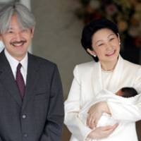 Prince Akishino and his wife, Princess Kiko, smile at photographers as they leave a Tokyo hospital with their newborn son, Prince Hisahito, on Sept. 15. | POOL PHOTO