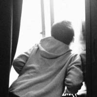 A teenage boy peers from a window at the Kibo no Ie (House of Hope) children\'s home in Tokyo. Some 60 percent of children here have suffered from abuse. | ERIC PRIDEAUX