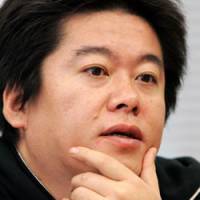 Takafumi Horie collects his thoughts in this file photo taken last Dec. 20. | AP PHOTO