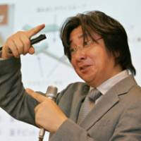 Jaw-Shen TSAI, a fellow at NEC Corp.\'s Nano Electronics Research Laboratories, speaks about his team\'s development of a quantum computer ? a still largely hypothetical device that would be dramatically more powerful than today\'s supercomputers ? at a news conference Tuesday in Tokyo. | AP PHOTO