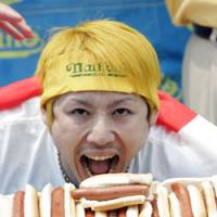 Takeru Kobayashi opens wide after winning the 2006 International July Fourth Hot Dog Eating Contest in Coney Island. The six-time champ was beat this year by American Joey Chestnut. | AP PHOTO
