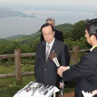 Full belly: Prime Minister Yasuo Fukuda speaks to reporters after the Group of Eight luncheon Tuesday at the Windsor Hotel Toya overlooking Lake Toya in Hokkaido. | KYODO PHOTO