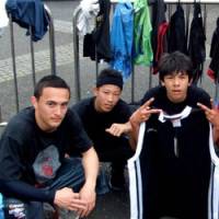 Streetwise: Yuki Sato (left), a member of Ballers of Beijing, hangs out at Yoyogi Park in Tokyo in April while another member of the group holds sportswear donated for a recycling project. | COURTESY OF G3