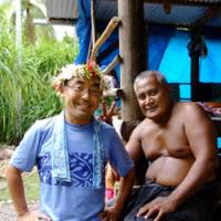 The quiet life: Shuichi Endo (left), photographer and representative of NPO Tuvalu Overview, hangs out with a local resident on Niutao Island in September. | COURTESY OF SHUUICHI ENDOU