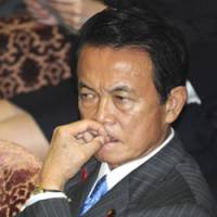 A lot on his mind: Prime Minister Taro Aso listens to questions during a Lower House Budget Committee session in October. | AP PHOTO