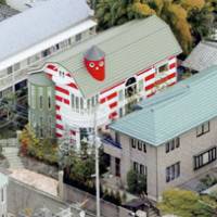There goes the neighborhood: Kazuo Umezu\'s home in Musashino, western Tokyo, is painted in the cartoonist\'s signature red and white stripes. | KYODO PHOTO