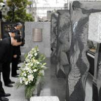 Paying their respects: Tokyo Metro Co. officials bow during a memorial service Sunday in Meguro Ward on the ninth anniversary of a fatal subway accident. | KYODO PHOTO