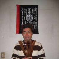 Future man: Fortuneteller Eisuke Ito displays his “zeichiku” bamboo sticks used in conjunction with I Ching to divine the future, in the Harajuku district of Shibuya Ward, Tokyo, in January. The past, present and future of fortunetelling