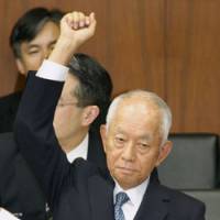 Mailman: Japan Post Holdings Co. President Yoshifumi Nishikawa raises his hand during a House of Representatives committee session Thursday. | KYODO