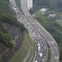 Nice while it lasted: Cars line the Chuo Expressway as vacationers return home after the midsummer Bon break. | KYODO PHOTO