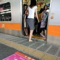 Safe haven: Passengers board a female-only car on the JR Chuo Line in Shinjuku Ward, Tokyo. | SATOKO KAWASAKI PHOTO
