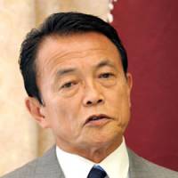 Making his case: Prime Minister Taro Aso speaks at LDP headquarters in Tokyo on Monday. Down in polls, Aso says only LDP can provide security