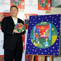 Dishing it out: Comedian and film director Takeshi Kitano shows off a dish he designed for Christmas at a promotional event Wednesday in Tokyo\'s Ginza district. | KYODO PHOTO