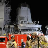Shipboard blaze: Firefighters on Sunday respond to a fire on an MSDF fleet support ship in Kanagawa Prefecture. | KYODO