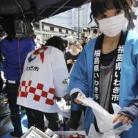 Better safe than sorry: A radiation detector is used on strawberries from Fukushima Prefecture during an event last April in Tokyo to promote the safety of Tohoku produce. | AP