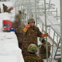 Snow job: Ground Self-Defense Force personnel in Hokkaido start work Saturday on giant snow sculptures for Asahikawa\'s winter festival, which starts Feb. 8 and will run for five days. | KYODO