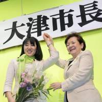 Double celebration: Naomi Koshi (left), newly elected mayor of the city of Otsu, and Shiga Gov. Yukiko Kada, hold hands Sunday evening to celebrate Koshi\'s victory. At 36, Koshi became the youngest-ever female mayor in Japan. | KYODO