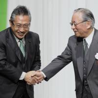 Your the man: Your Party chief Yoshimi Watanabe (left) greets Taichi Sakaiya, a strategy adviser for Osaka Ishin no kai (One Osaka) and ex-leader of the now-defunct Economic Planning Agency, and thanks him for giving a speech Saturday at Your Party\'s general meeting in Tokyo. | KYODO