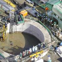 Debris clogs search: The search for five missing workers continues Wednesday morning in a flooded undersea tunnel at an oil refinery in Kurashiki, Okayama Prefecture. | KYODO