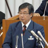 Unyielding: Mayor Susumu Inamine of Nago, Okinawa, gives his policy speech Monday before the city assembly. | KYODO