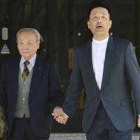 Retrial rejection: Shoji Maekawa exits the Nagoya High Court with his father, Reizo, on  Wednesday after his appeal for a retrial of his 1986 conviction over the slaying of a 15-year-old girl was turned down. | KYODO