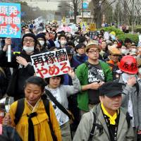Long goodbye: Antinuclear protesters rally outside the Diet building Sunday in Tokyo, on the eve of the second anniversary of the March 11, 2011, quake and tsunami that triggered one of the worst nuclear catastrophes the world has seen. Protesters rail against Abe, reactors
