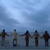 As one: People join hands Sunday morning on a beach in Iwaki, Fukushima Prefecture, ahead of the second anniversary of the Great East Japan Earthquake. | KYODO