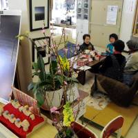 Some of the 140 evacuees from Futaba, Fukushima Prefecture, relax in a makeshift tea room set up in the former Kisai High School building in Kazo, Saitama Prefecture. | SATOKO KAWASAKI