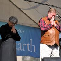 In memory: Composer Ryuichi Sakamoto (left), nature writer C.W. Nicol (foreground) and singer Tokiko Kato (third from left) observe a moment of silence at a memorial gathering at Hibiya Park in Tokyo. | YOSHIAKI MIURA