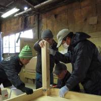 All for one: Three evacuees (right) attend a carpentry workshop in Minamisoma, Fukushima Prefecture, on Feb. 24. | MIZUHO AOKI