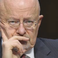 All ears: U.S. Director of National Intelligence James Clapper listens during a Senate Intelligence Committee hearing on global threats Tuesday in Washington. | AP