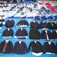 Collared: Around 90 high school girls\' uniforms and jerseys confiscated from the home of Yasushi Uehara, 40, are displayed by the Kanagawa Prefectural Police. | KYODO