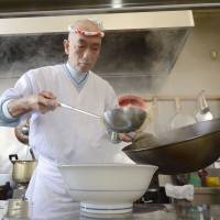 Using his noodle: Tsutomu Nozaki serves ramen at his shop in Aizuwakamatsu, Fukushima Prefecture, on Feb. 9. | KYODO