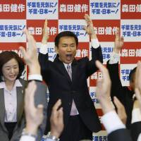 One more time: Chiba Gov. Kensaku Morita celebrates with supporters in the city of Chiba Sunday after being assured of re-election. | KYODO