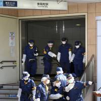 Rush-hour attack: Police investigate the scene of a stabbing rampage that left four people wounded near the Toyocho subway station in Koto Ward, Tokyo, Tuesday morning. | KYODO