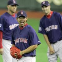 Boston Red Sox pitcher Daisuke Matsuzaka laughs during a Boston workout on Monday at Tokyo Dome. | AP PHOTO