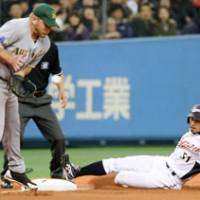 Good form: Japan outfielder Ichiro Suzuki slides into third safely on a single by Atsunori Inaba in the third inning of the WBC exhibition game against Australia on Tuesday at Kyocera Dome. Japan won 8-2. | KYODO PHOTO