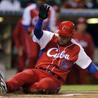 Still in the hunt: Cuba\'s Michel Enriquez slides home safely with a run against Mexico on Monday night in a World Baseball Classic second-round game in San Diego. | AP PHOTO
