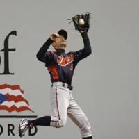 Hauling it in: Right fielder Ichiro Suzuki makes a running catch on a flyball hit by South Korea’s Jeong Keun Woo in the fifth inning on Thursday night. Japan continues momentum