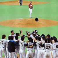 Party time: The Fighters gather at home plate to celebrate Terrmel Sledge\'s game-winning grand slam in the bottom of the ninth inning against the Eagles at Sapporo Dome on Wednesday. | KYODO PHOTO