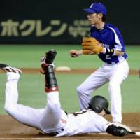 Aggressive style: Yomiuri Giants second baseman Shigeyuki Furuki safely slides into first base in the fourth inning of Game 2 of the CL Climax Series second stage against the Chunichi Dragons at Tokyo Dome on Thursday. | KYOD PHOTO