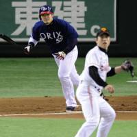 Busy shift: Takahiro Okada hits an RBI single for Orix in the first inning against the Giants on Sunday. | KYODO PHOTO