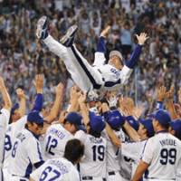 What a feeling: The Chunichi Dragons give manager Hiromitsu Ochiai a traditional doage after winning the Central League Climax Series championship on Saturday in Nagoya. | KYODO PHOTO